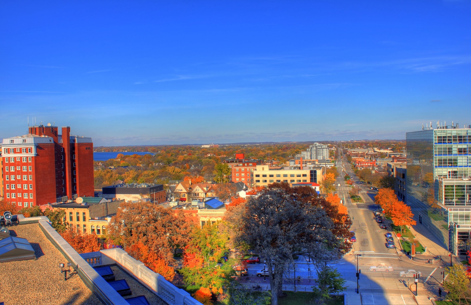 View across Madison, Wisconsin, with downtown buildings and autumn foliage.